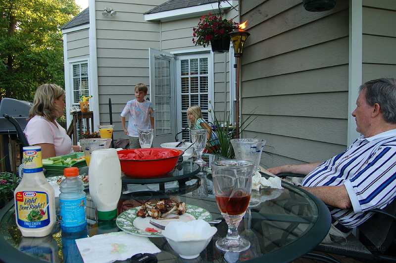 AbbysBirthday_2006_004.JPG - The family gathered at John & Sharon's on Saturday, July 1, to celebrate Abby's birthday.  Remnants of the great meal John & Sharon prepared can be seen in the foreground, and in Pop-Pop's tummy.