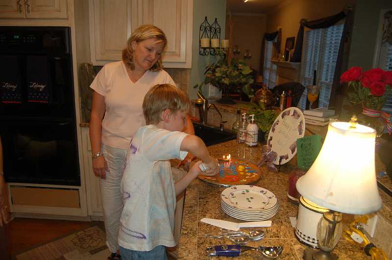 AbbysBirthday_2006_023.JPG - Chace & Mom prepared yummy plates of ice cream and cake.  Sharon & Abby made the cake.